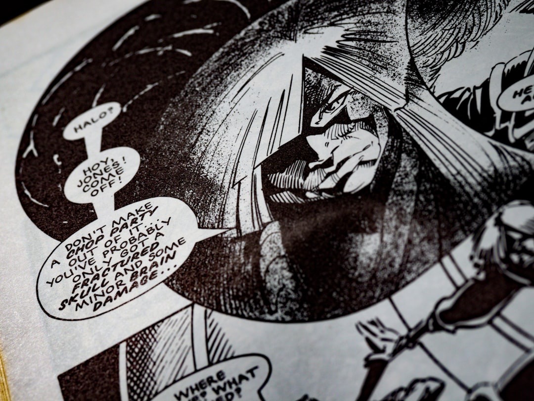 Close-up of an open comic book page with ink illustrations.